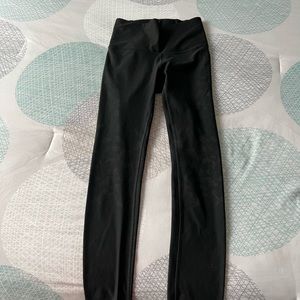 Size 4 black lulu lemon leggings with camo print throughout